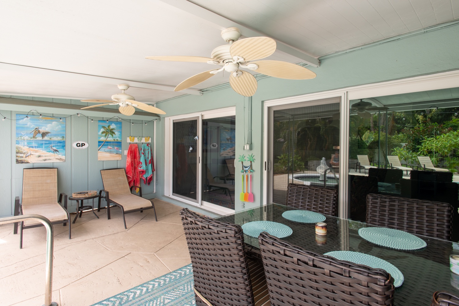 Covered patio area between the house and the pool