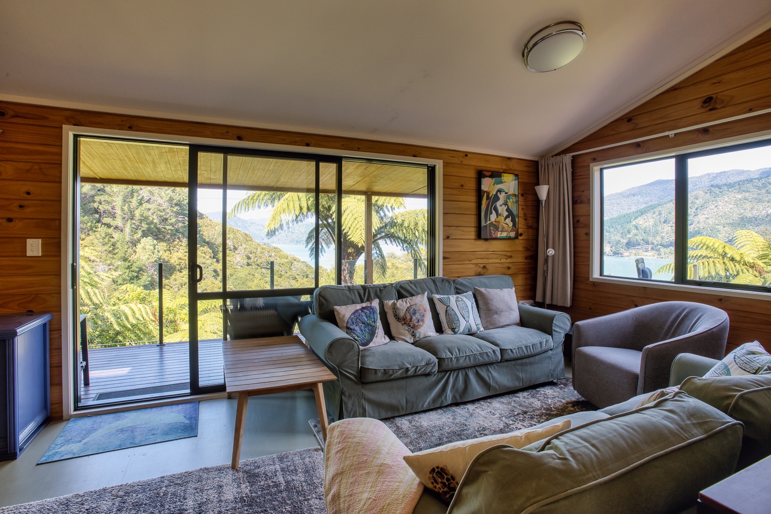 Sink into plush sofas while tropical views frame your perfect getaway through floor-to-ceiling windows.