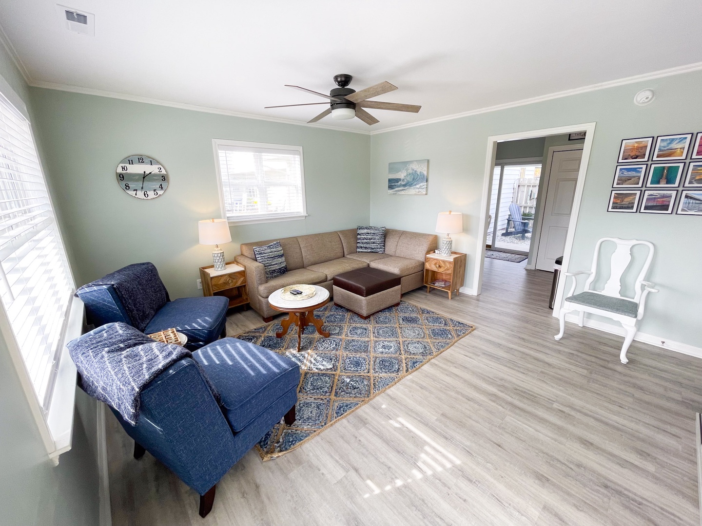 Settle into your spacious living room where coastal blues meet warm whites, creating the perfect spot to unwind after your adventures.