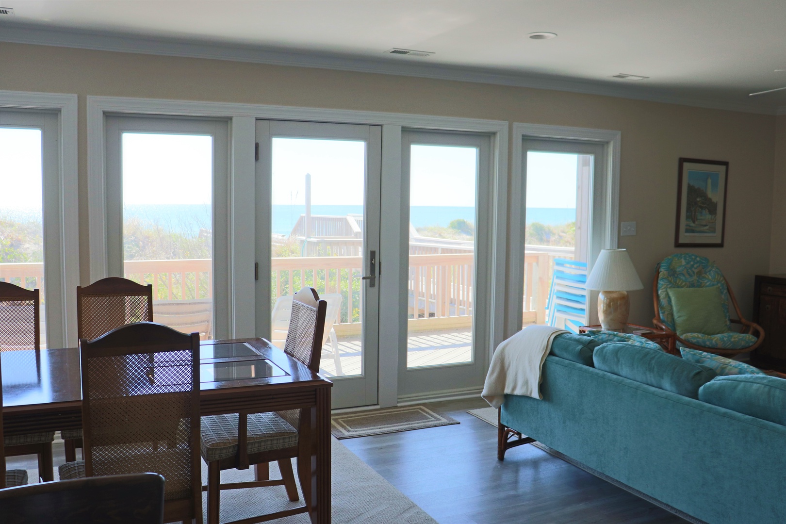 Your bright living space opens to a private balcony where turquoise waters meet the horizon through floor-to-ceiling windows.