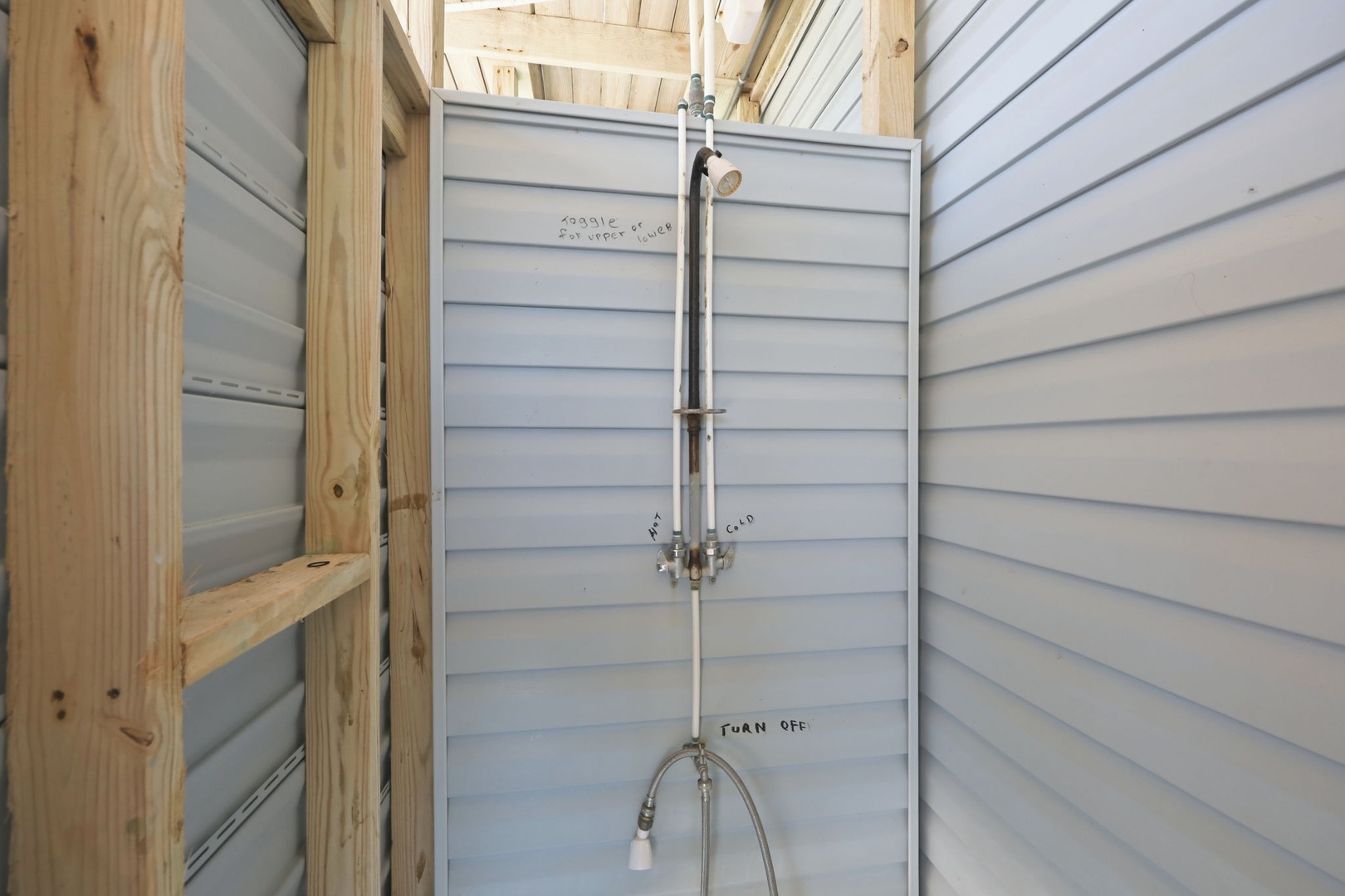 This freshly constructed outdoor shower features quality fixtures and thoughtful design details, perfect for rinsing off after beach days or pool time.