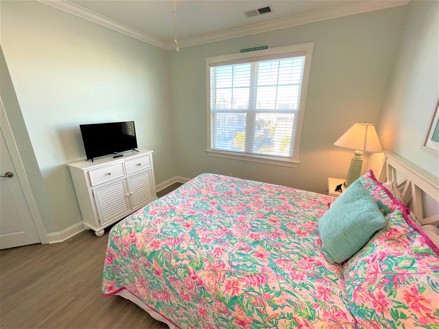 Rest comfortably in your bright bedroom featuring tropical-print bedding, personal TV, and soothing natural light from oversized windows.