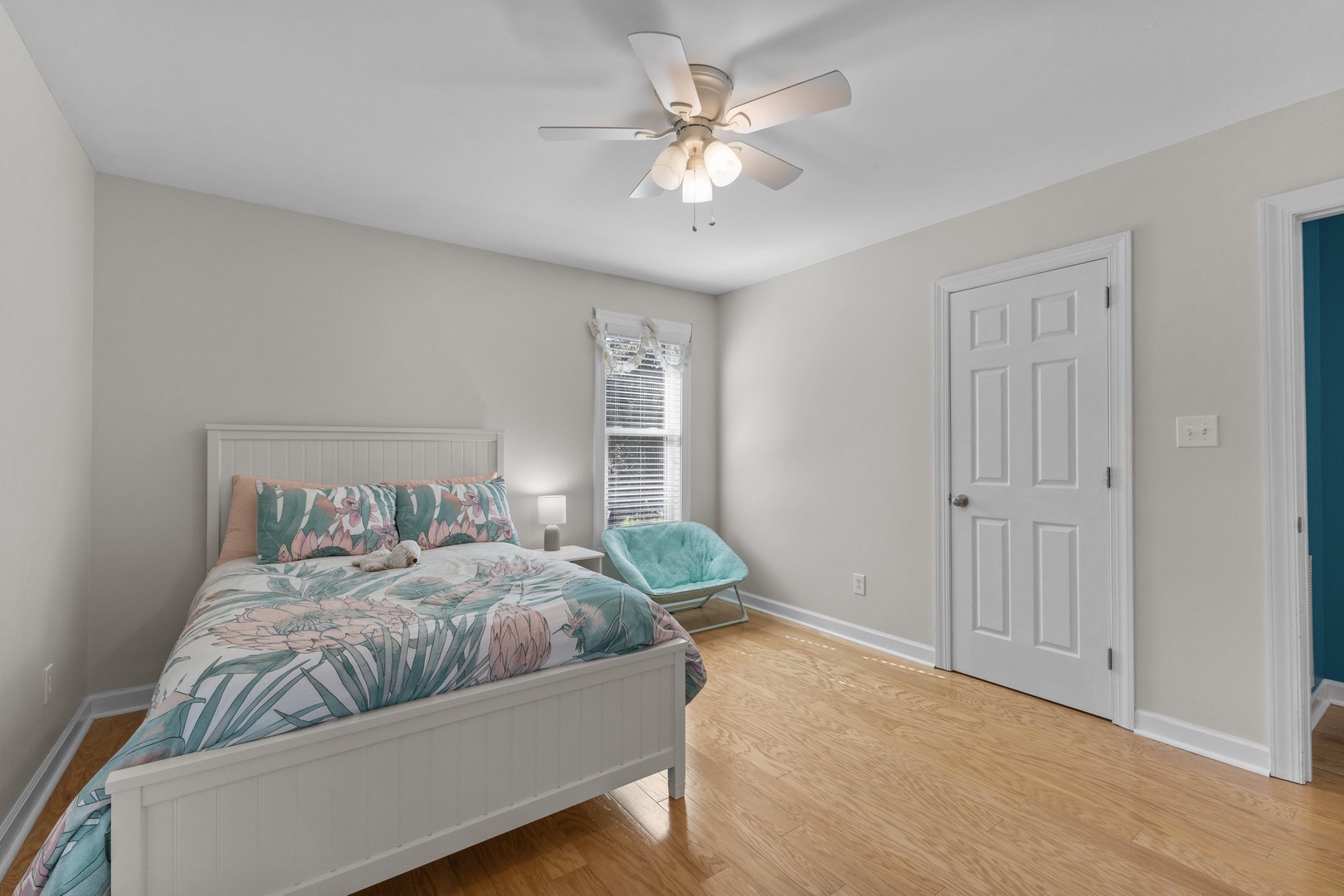 Drift off in your tropical-themed bedroom with soft linens, warm hardwood floors, and a gentle ceiling fan keeping you comfortable.