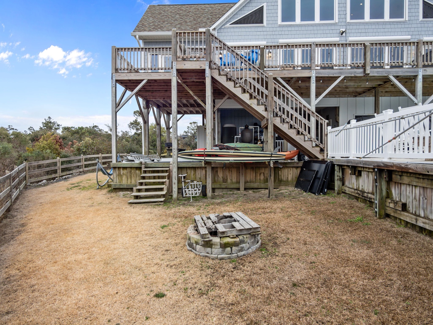 Your private backyard oasis features a stone fire pit for cozy evenings and multi-level decks perfect for outdoor dining and relaxation.