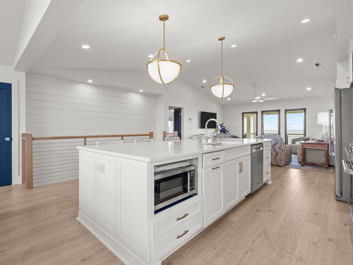 Your spacious kitchen island becomes the heart of memorable meal prep, featuring elegant pendant lighting and modern appliances for effortless cooking.