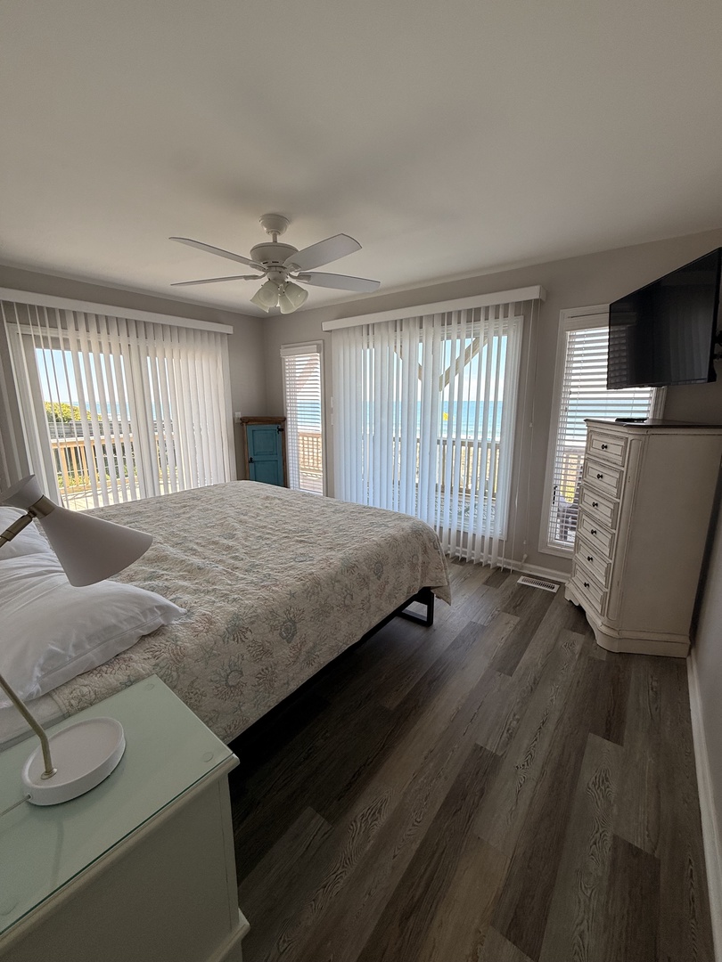 Settle in and unwind in your cozy bedroom with modern wood accents. Natural light filters through blinds, creating a peaceful retreat after exploring the area.