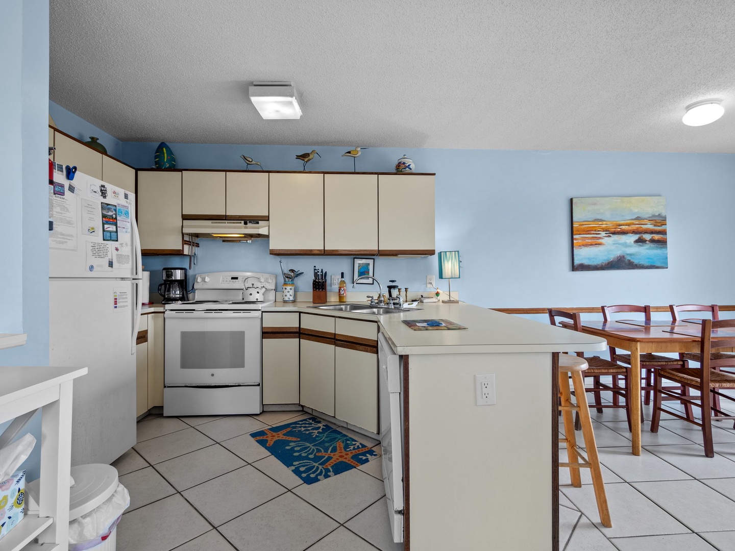 Your fully equipped kitchen features everything you need to create memorable meals, from morning coffee to family dinners around the spacious dining table.