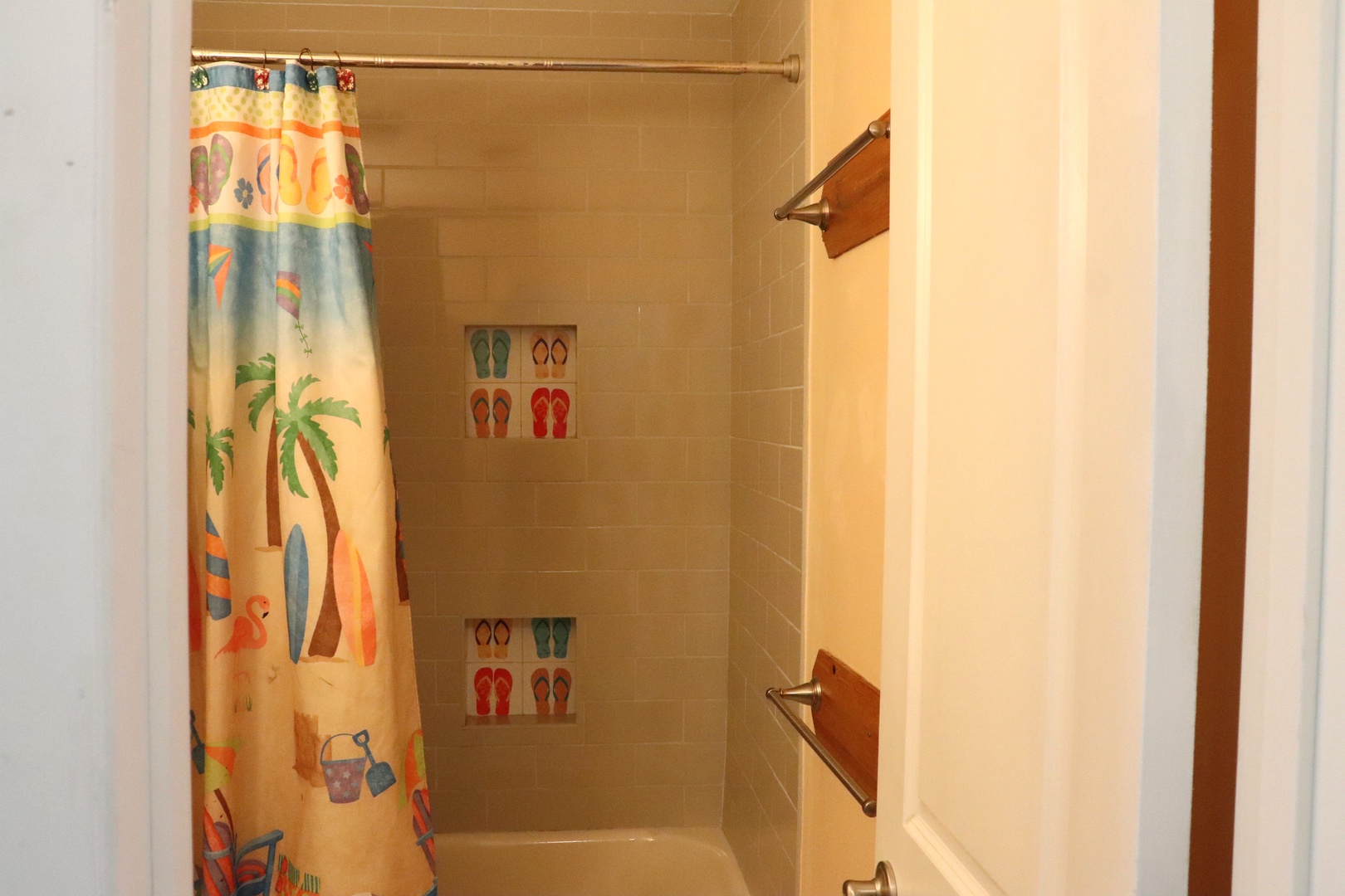 Your private bathroom features a cheerful beach-themed shower with playful tile accents—perfect for rinsing off after a day of adventure.