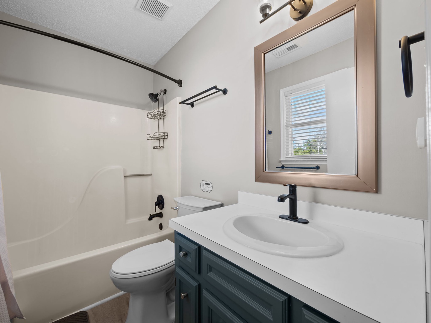 Refresh in your modern bathroom with tub-shower combo, stylish vanity, and thoughtful amenities for a comfortable stay.