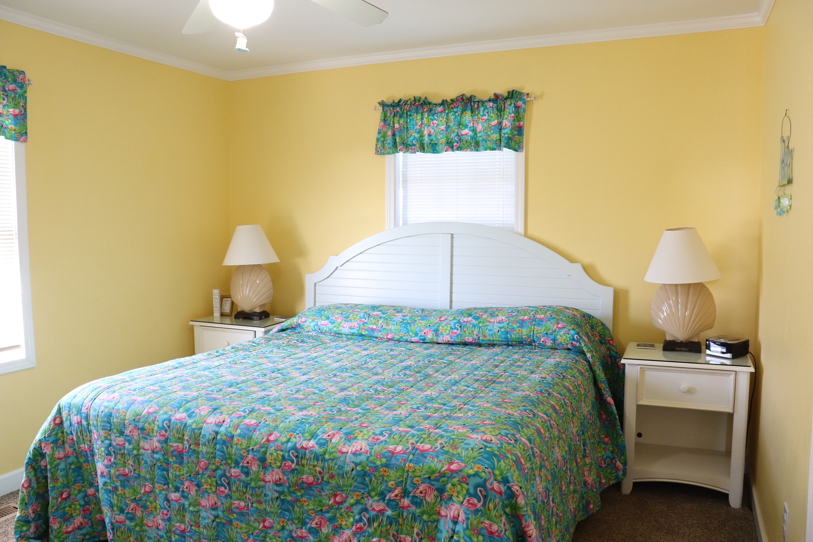 Drift off to sleep in this cheerful bedroom with sunny yellow walls and tropical-themed bedding that brings vacation vibes indoors.