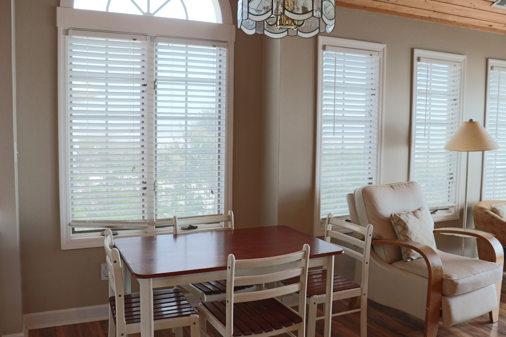 Enjoy meals at your private dining table while soaking up natural light through elegant shutters.