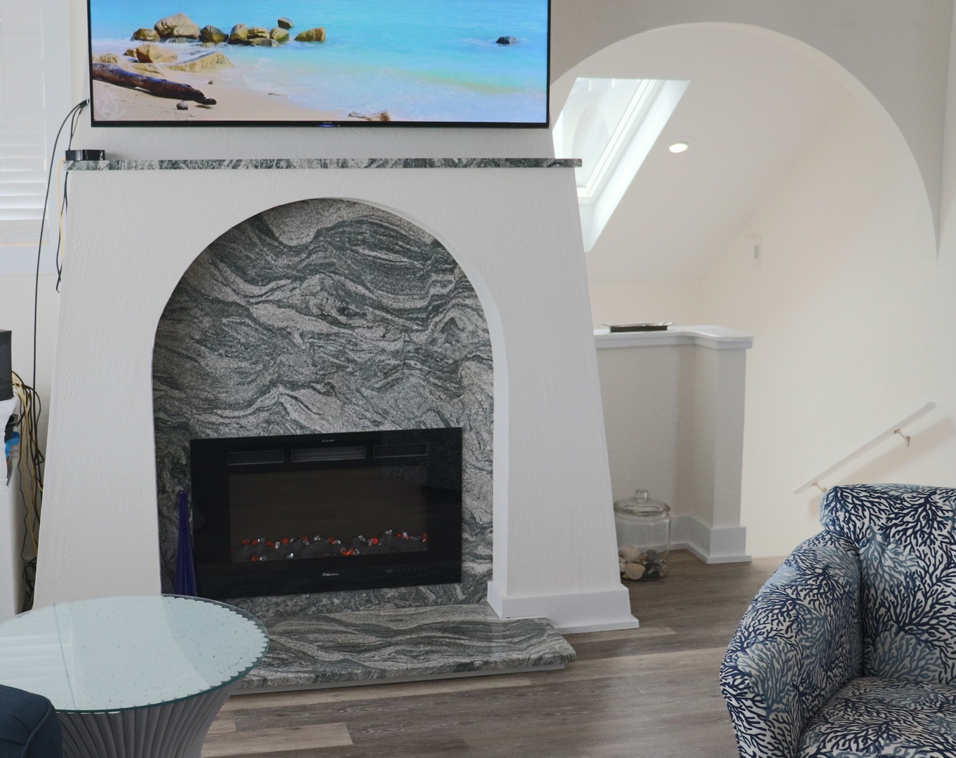 Cozy up in your stylish living room with a stunning marble fireplace and beachside TV views.