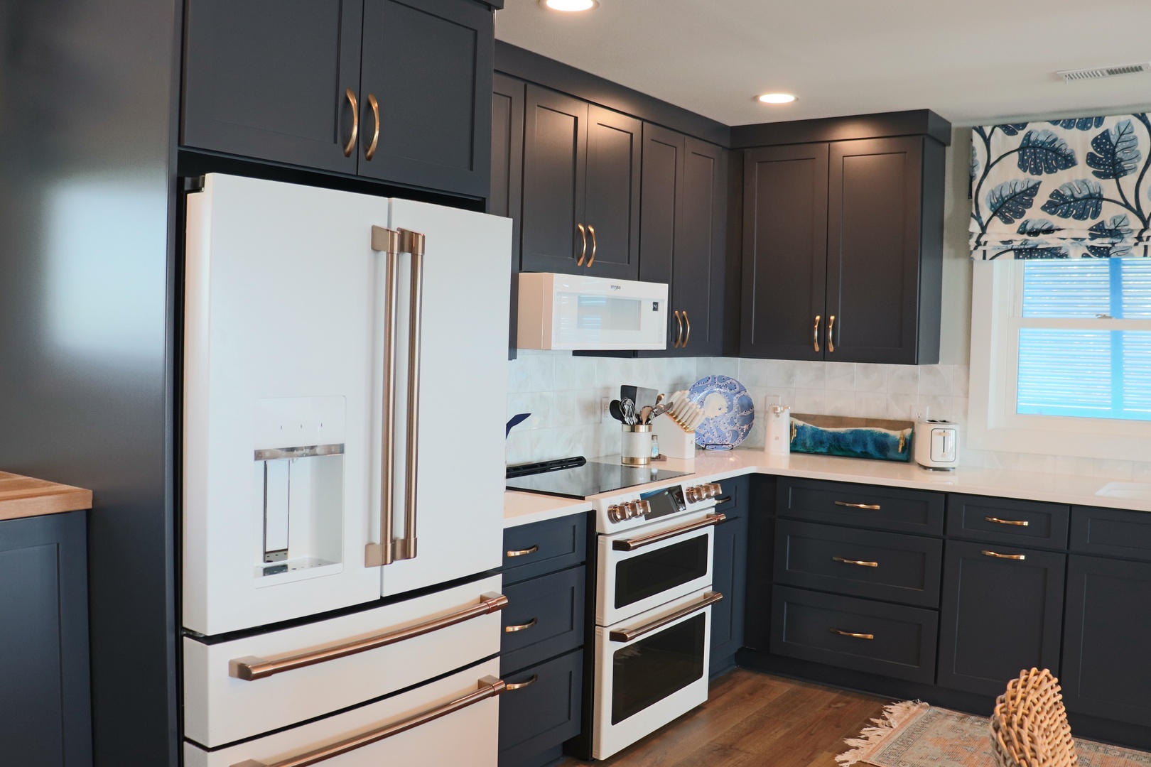 Your stylish kitchen features modern navy cabinets, stainless steel appliances, and elegant quartz counters—perfect for cooking memorable meals during your stay.