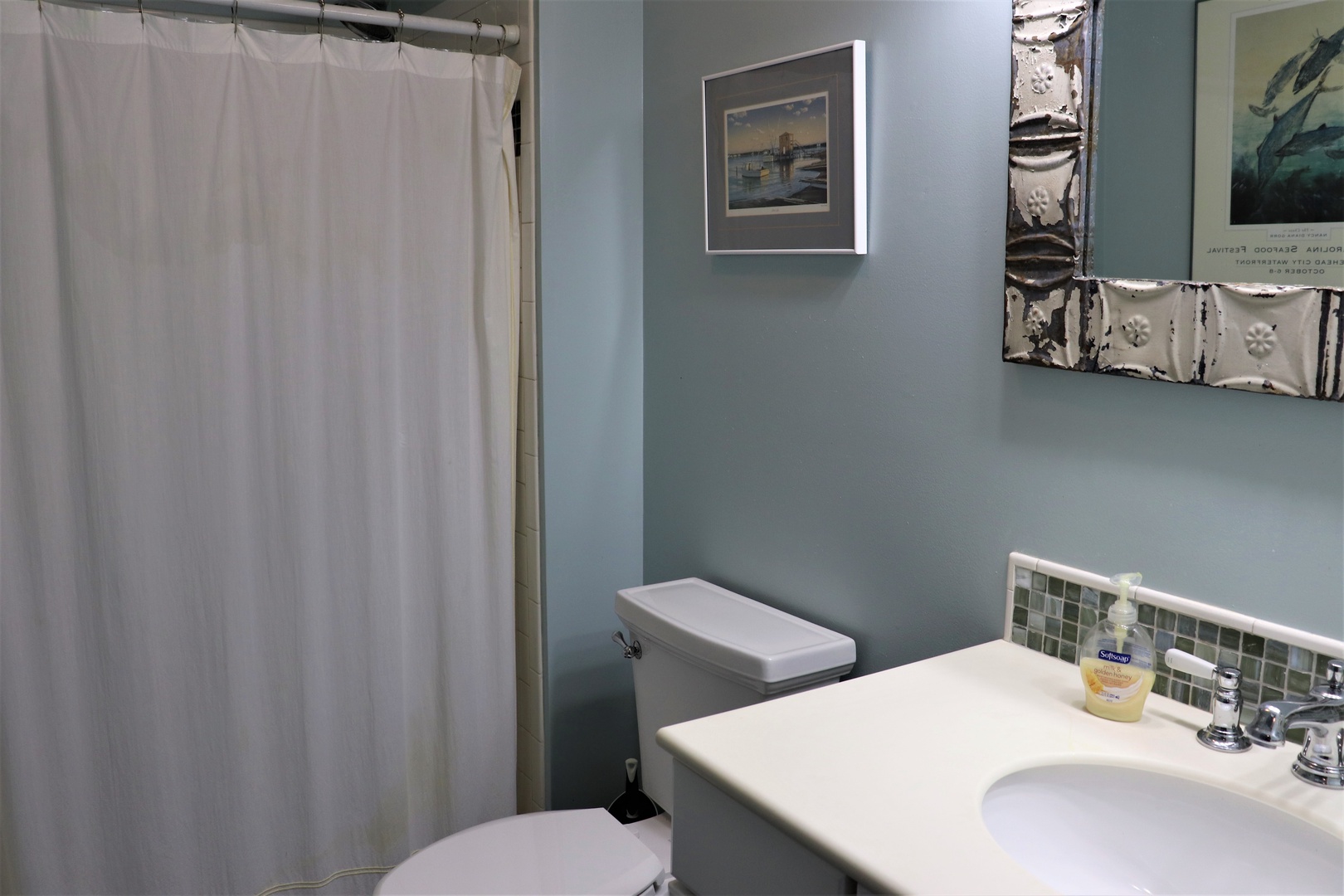 Refresh in your private bathroom with soothing blue walls, sparkling tile accents, and all the amenities you need for a comfortable stay.
