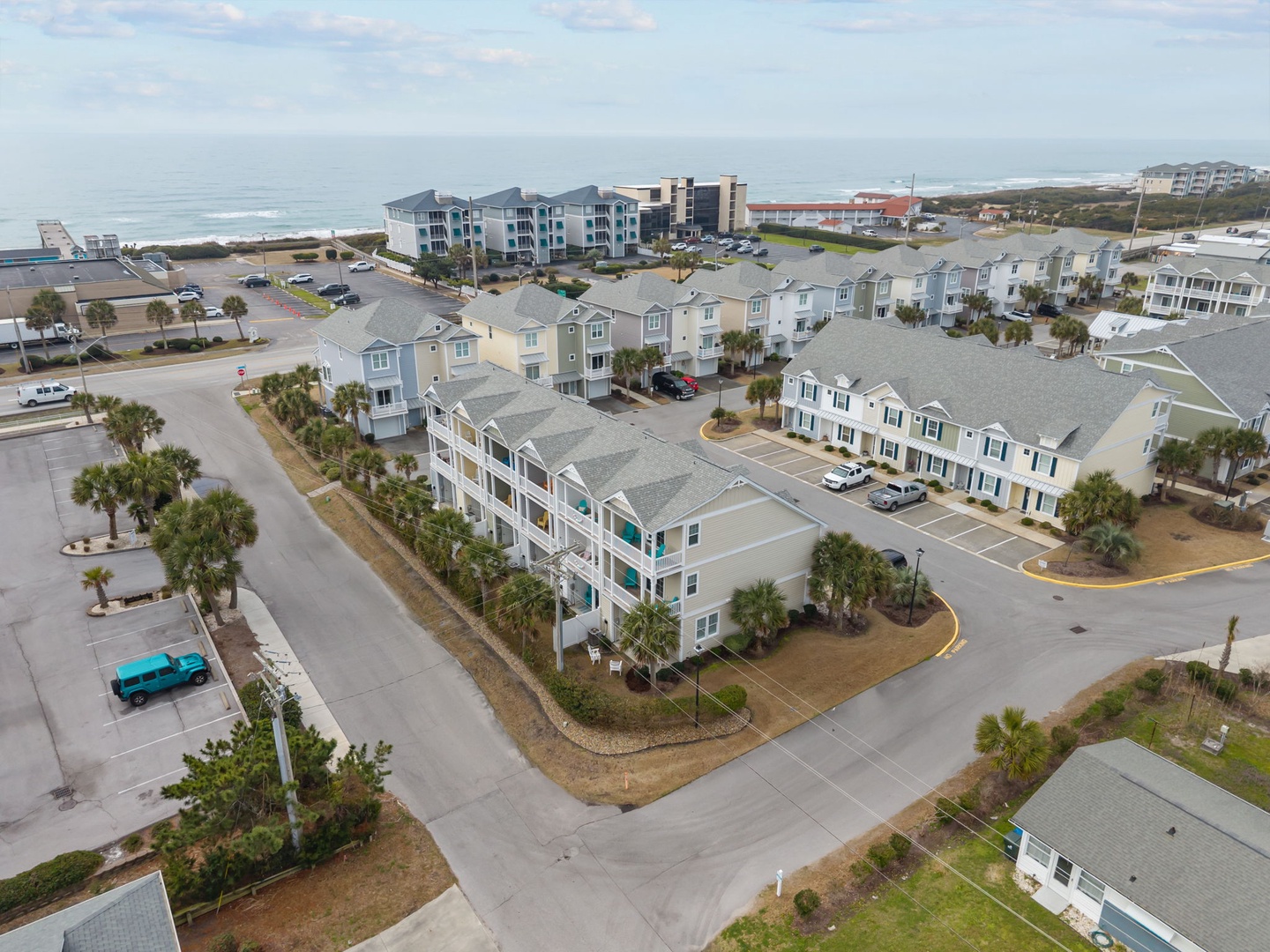 Aerial view of beachside vacation rental community with ocean proximity and coastal charm.