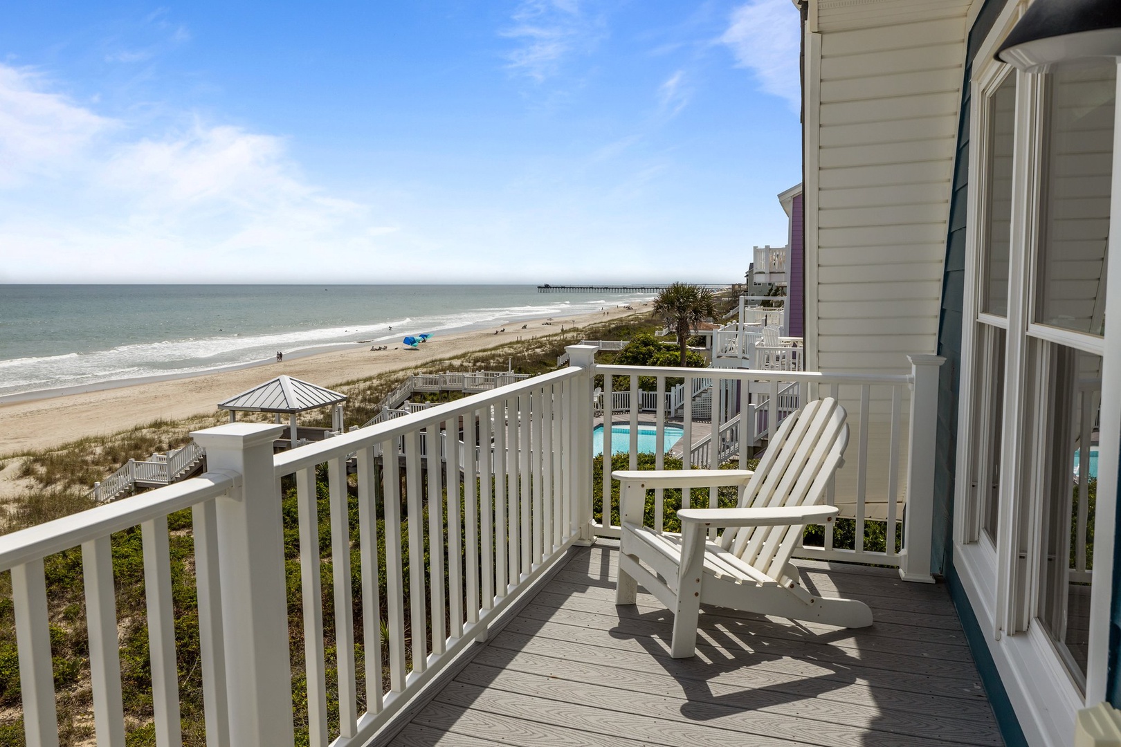 Unwind on your private deck with sweeping ocean views and white Adirondack chairs perfect for morning coffee or sunset watching.