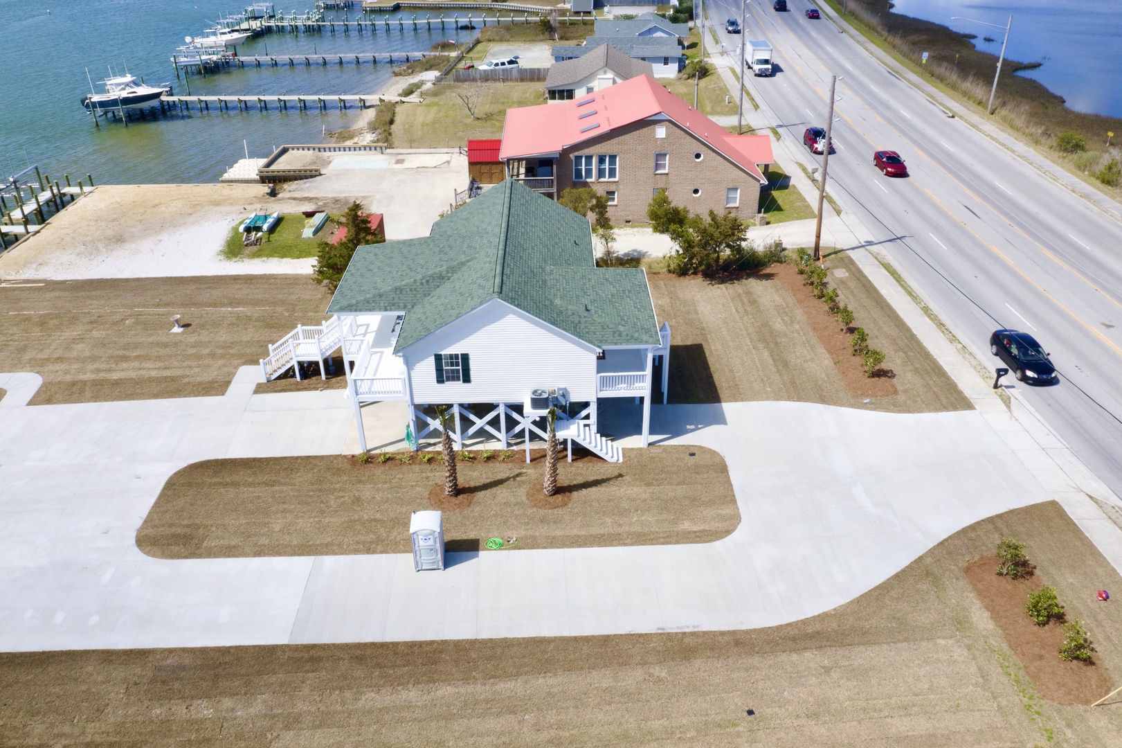 Waterfront vacation home with boat dock access, positioned perfectly between calm bay waters and main road for easy arrival.