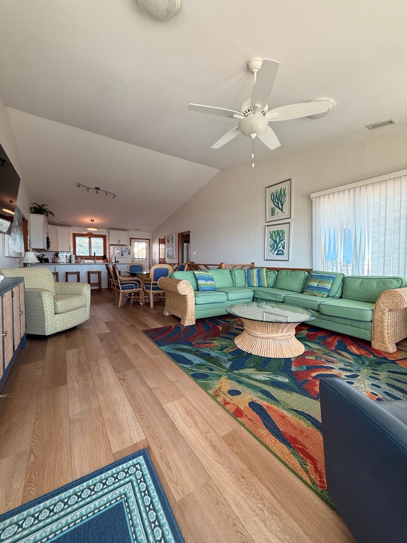 Step into your bright, airy retreat where coastal vibes meet comfort. Sink into the spacious sectional, enjoy meals at the dining table, or simply relax under the vaulted ceilings—your perfect beach escape awaits.