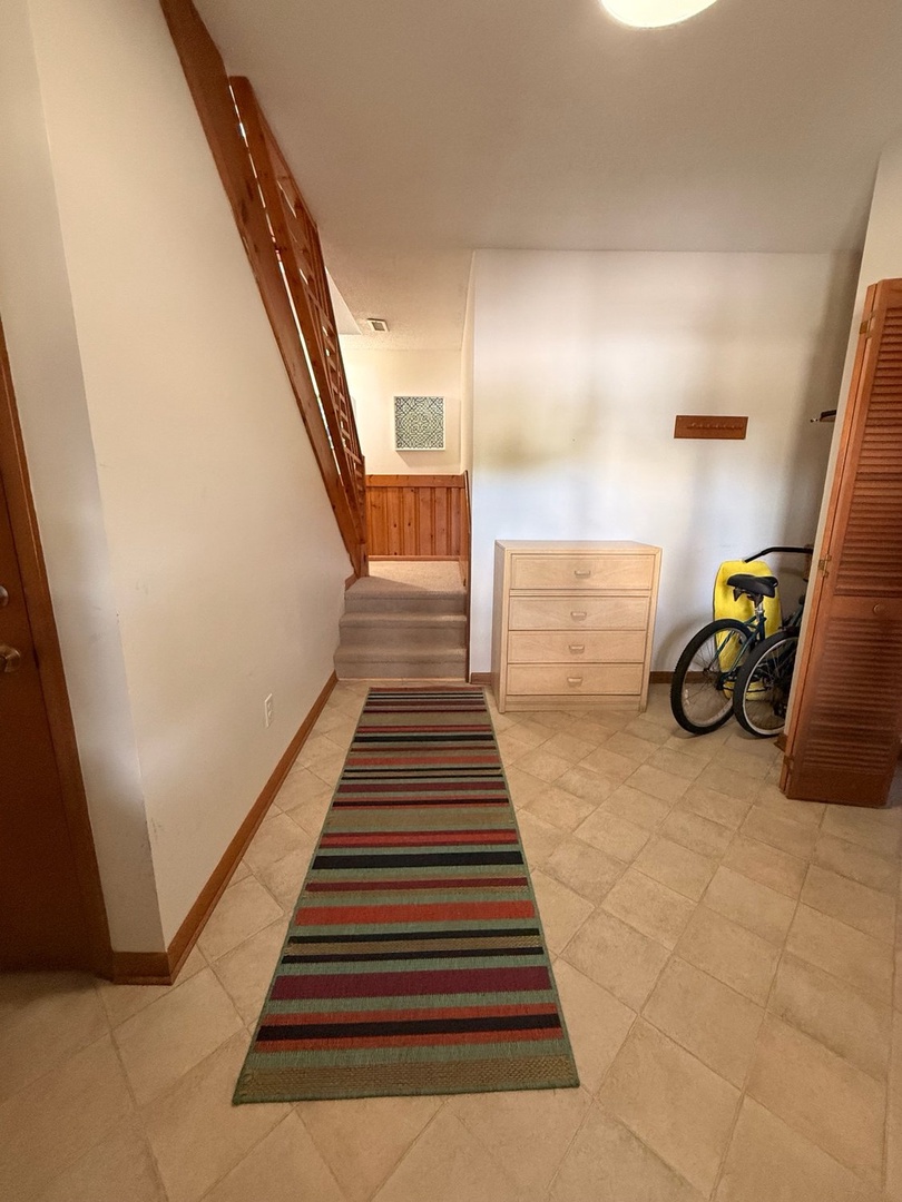 Step into your welcoming entryway with warm wood accents and plenty of storage space for all your vacation gear—bikes included for exploring the area at your leisure.