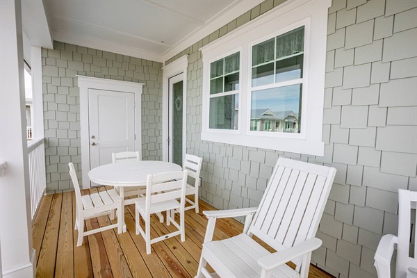 Your private covered porch offers a peaceful retreat with comfortable seating and dining space, perfect for morning coffee or evening relaxation.