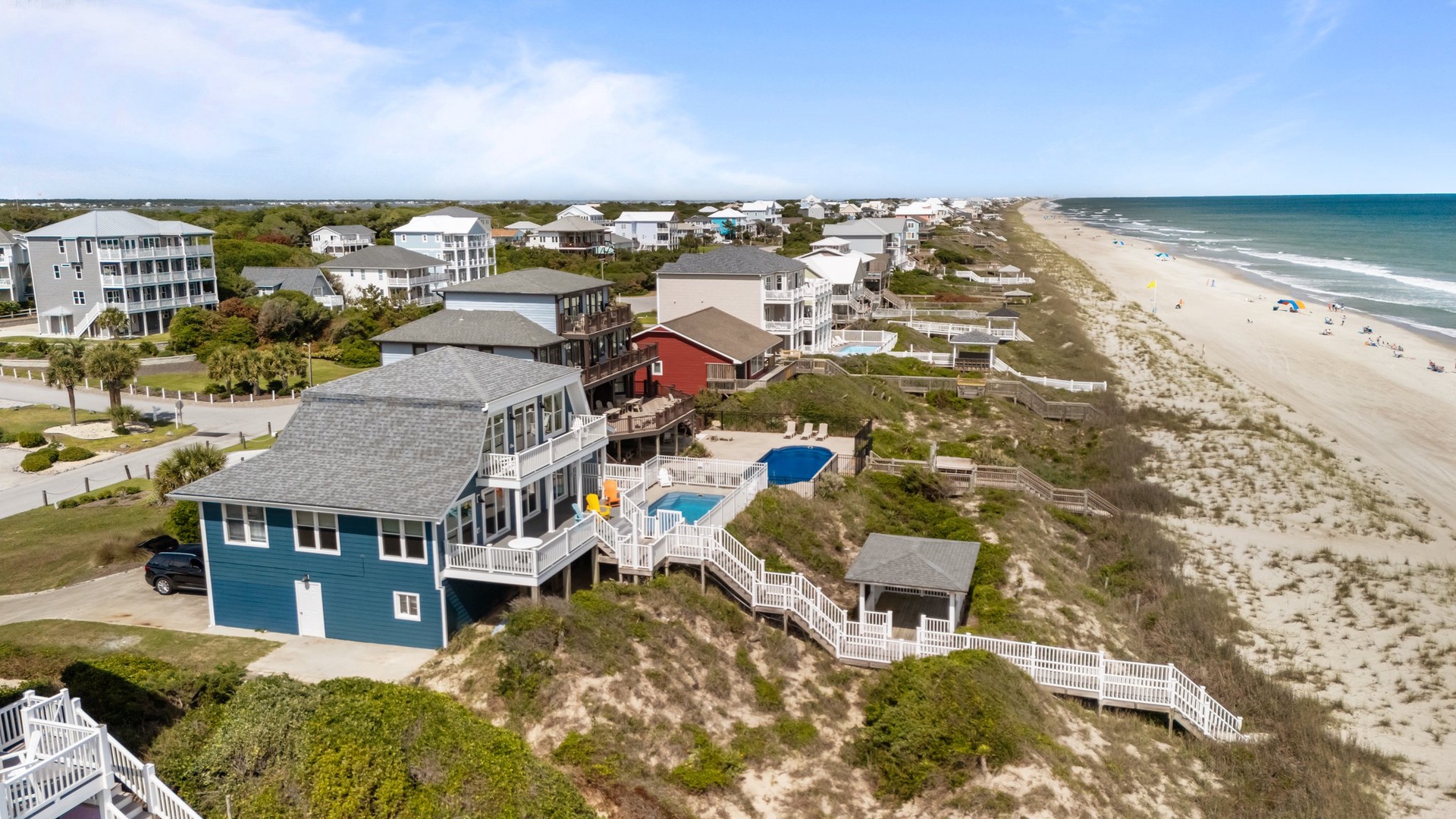 Beachfront vacation homes with pool facilities positioned along pristine coastline with direct beach access.