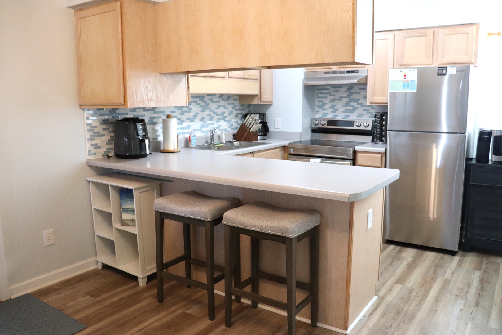 Your fully equipped kitchen awaits with modern appliances, granite counters, and a breakfast bar perfect for morning coffee or casual meals.