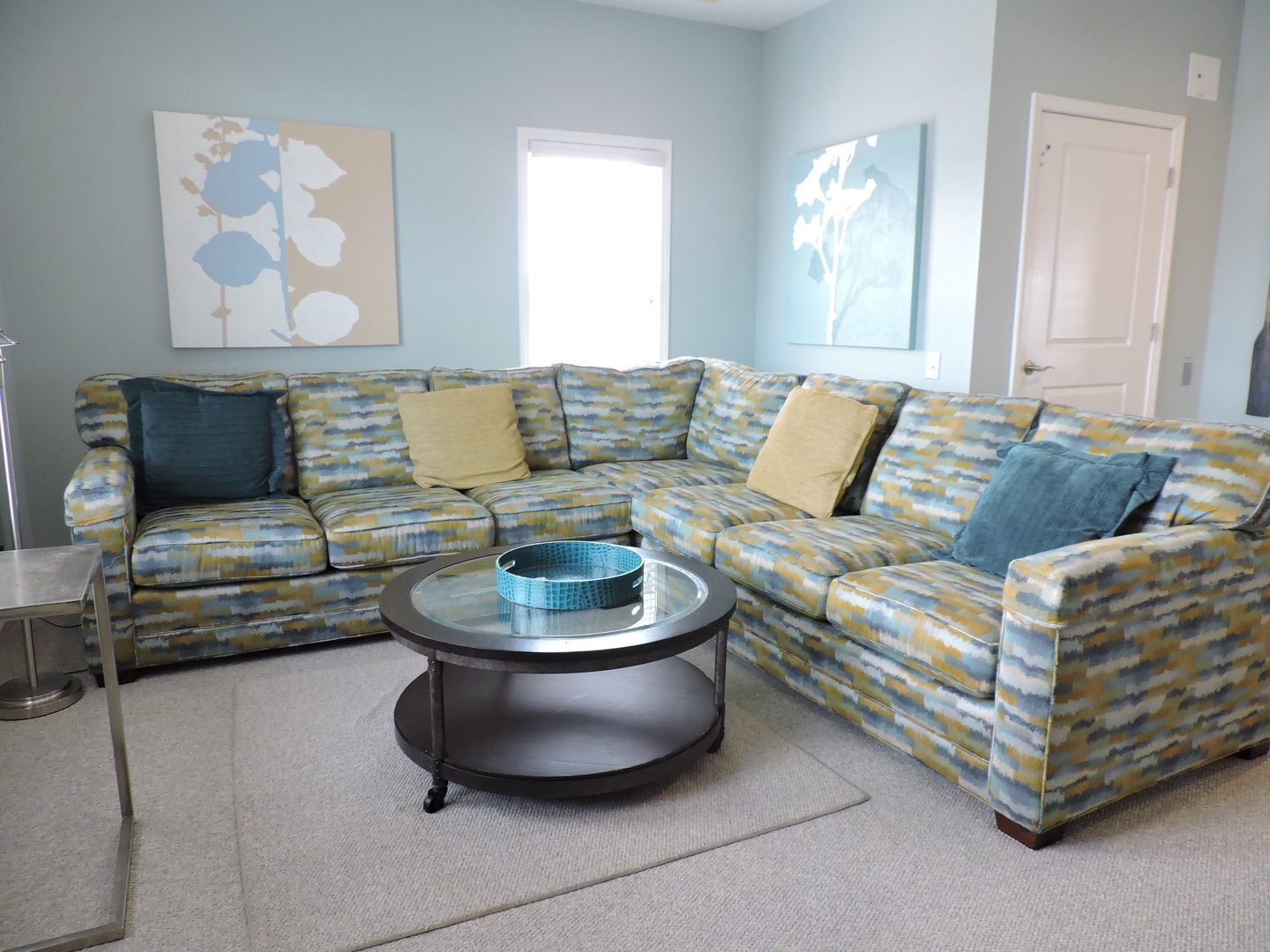 Sink into this spacious L-shaped sectional where soft blues and yellows create your perfect relaxation haven for movie nights or morning coffee.