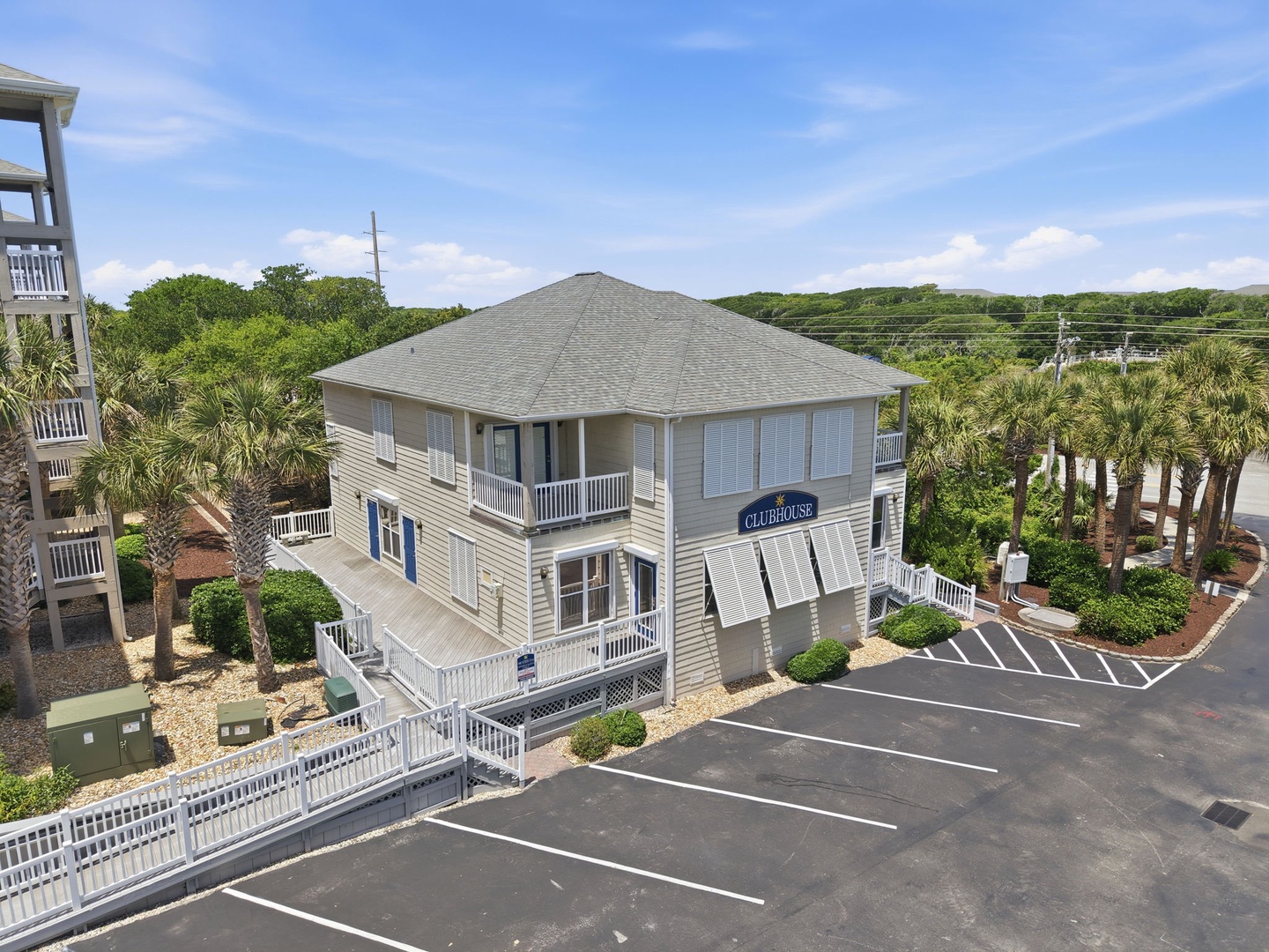 Beachside vacation retreat with distinctive architecture, nestled among palm trees and lush coastal greenery with convenient on-site parking.