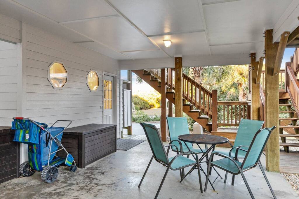 Your covered patio offers shade and breeze with comfortable seating where you can sip morning coffee or unwind after beach days.