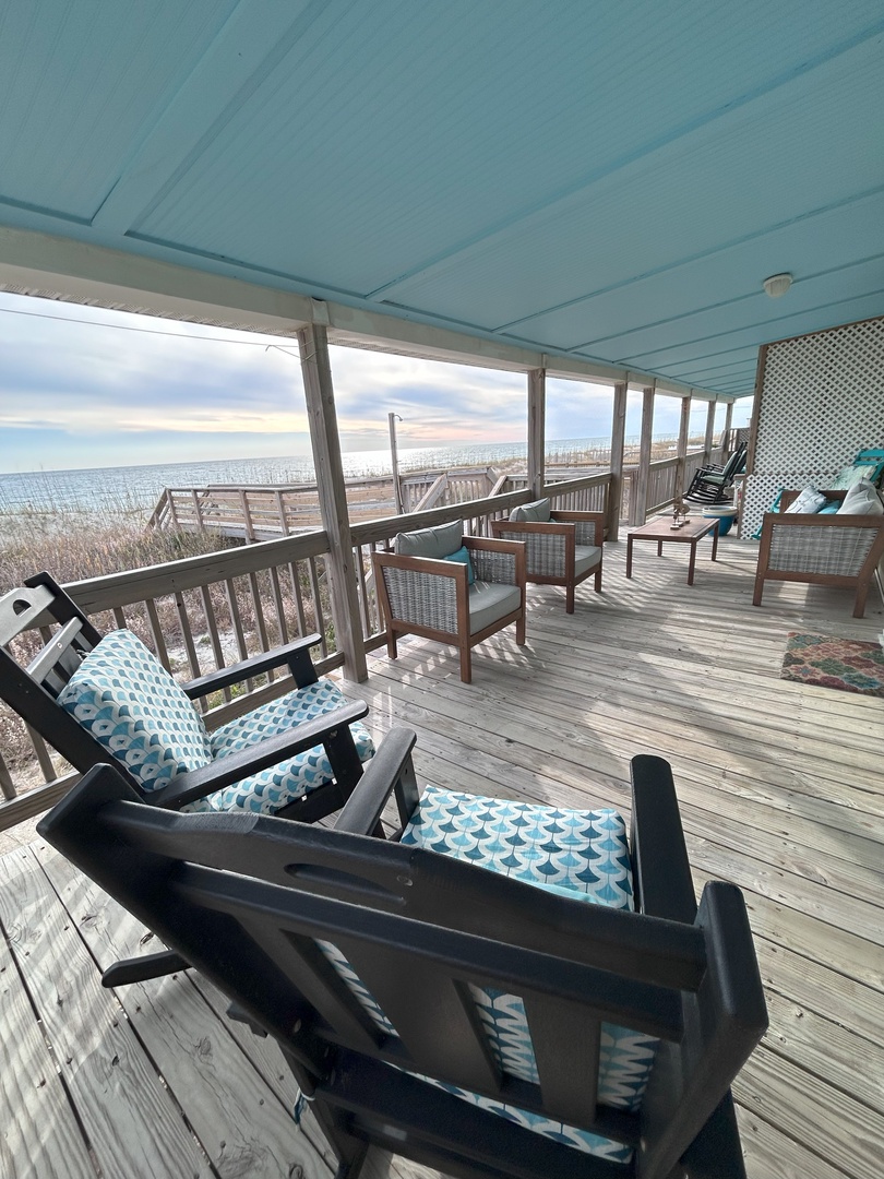 Your private oceanfront deck awaits with comfortable seating where you can sip morning coffee while watching waves crash just steps away.