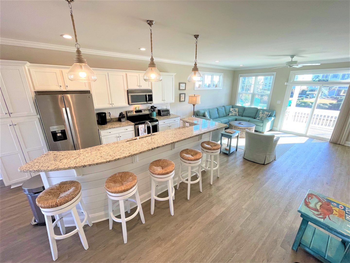 Your open-concept paradise blends modern kitchen with cozy living space, perfect for gathering around the granite island while natural light streams in.