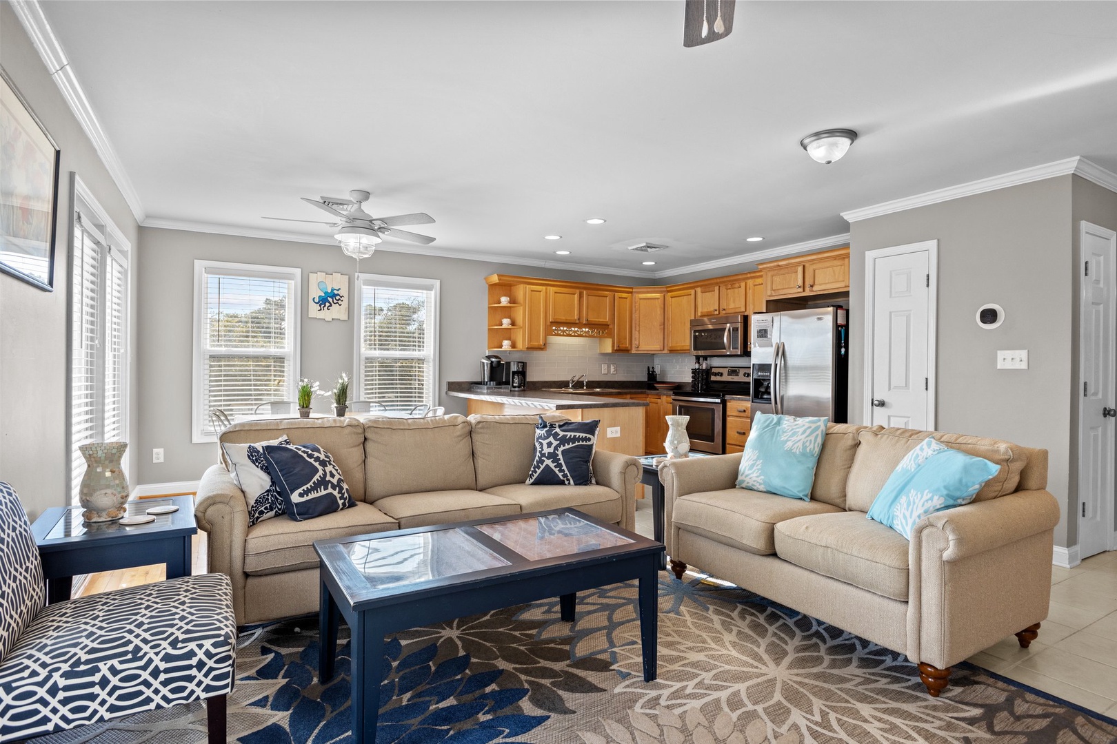 Relax in your spacious open-plan living area where comfort meets style, featuring plush seating and a fully equipped kitchen for memorable meals together.