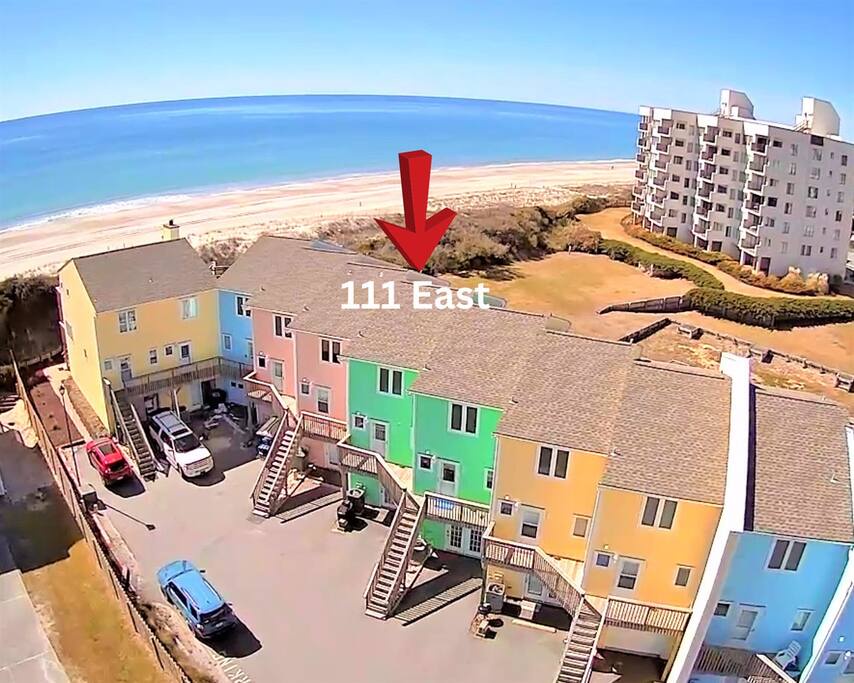 Aerial view of the colorful beachfront property located at 111 East, just steps from pristine sandy shores.