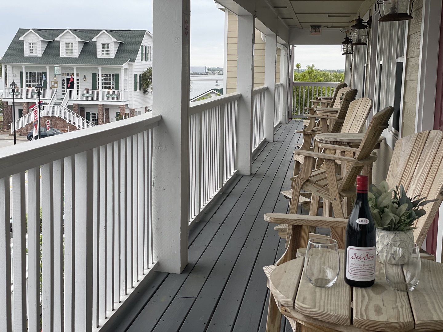 Unwind on your private balcony with wooden chairs lined up perfectly for evening wine and waterfront views.