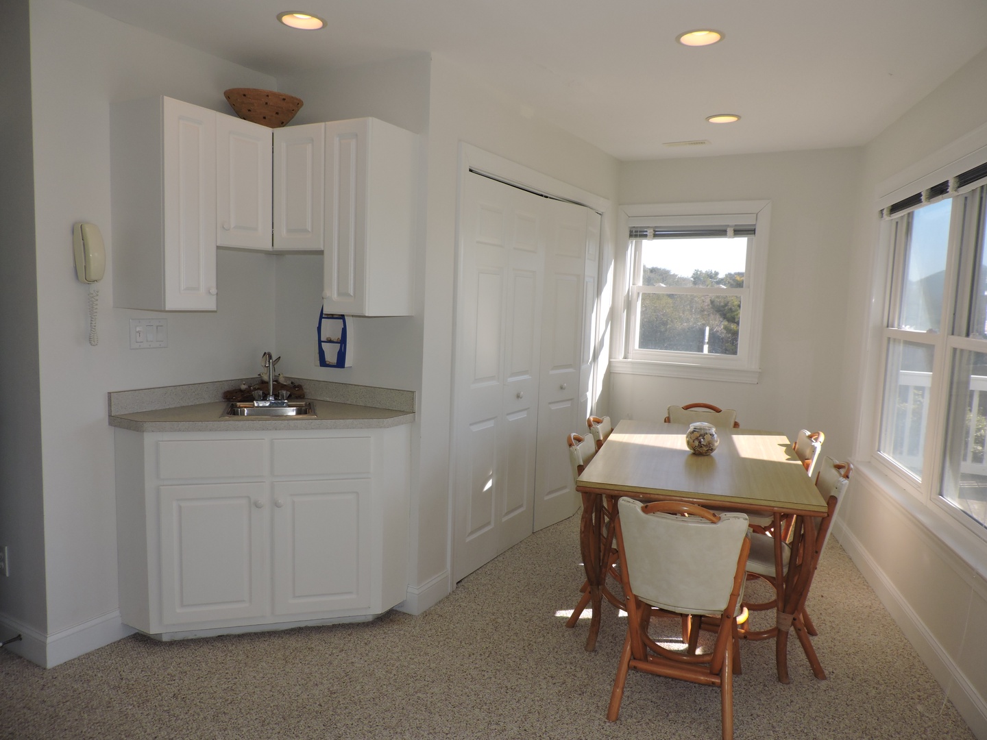 Enjoy morning coffee in your bright kitchenette with dining table, perfectly positioned by sunny windows for a cheerful start.