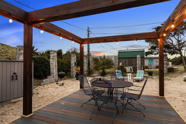 Your private deck offers the perfect evening retreat, with warm string lights creating ambiance for outdoor dining under desert skies.
