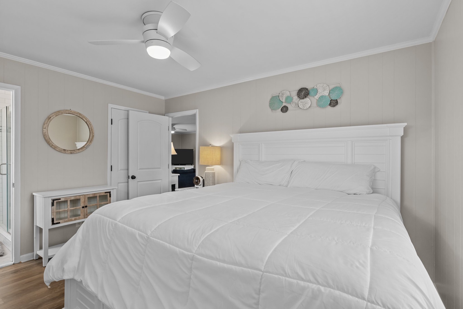 Drift off to sleep in your serene bedroom, where soft white linens and gentle coastal touches create the perfect retreat.