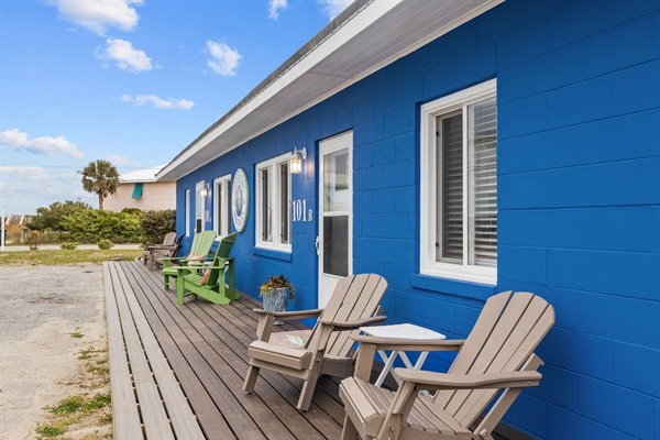Relax on your private deck with comfortable Adirondack chairs, soaking up coastal vibes outside your charming blue cottage.