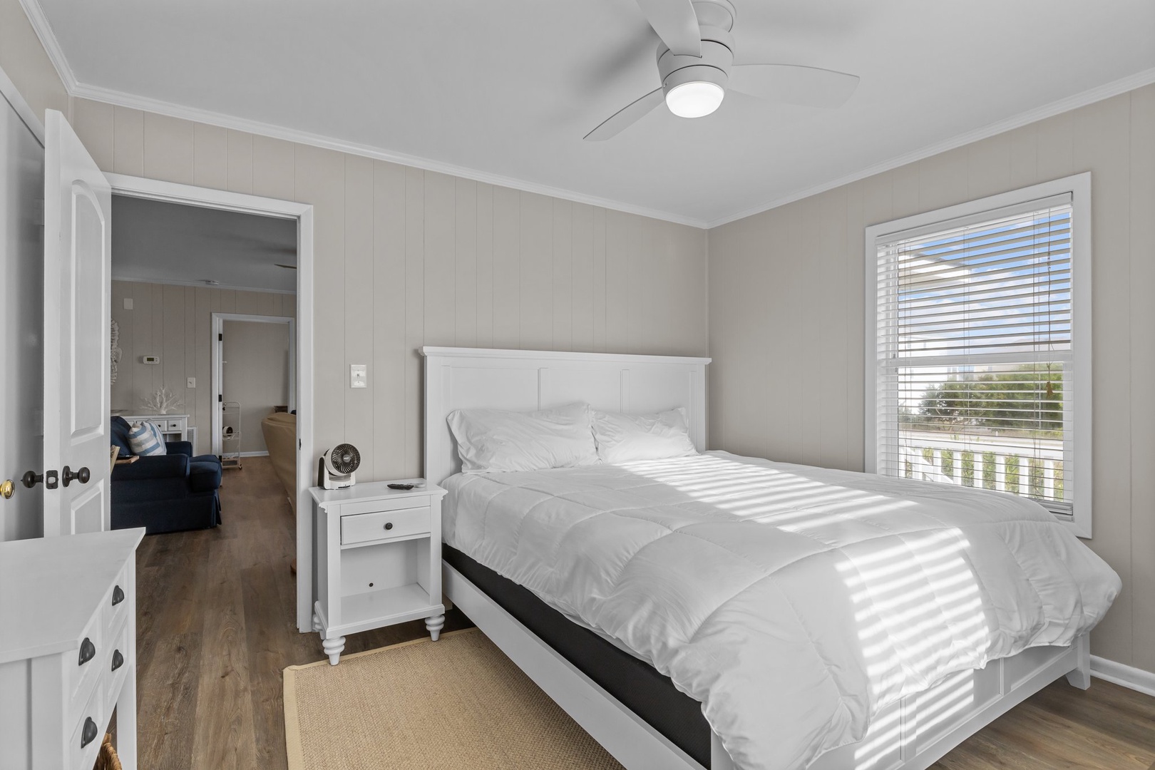 Drift into peaceful sleep in your bright bedroom with crisp linens and gentle morning light filtering through the blinds.