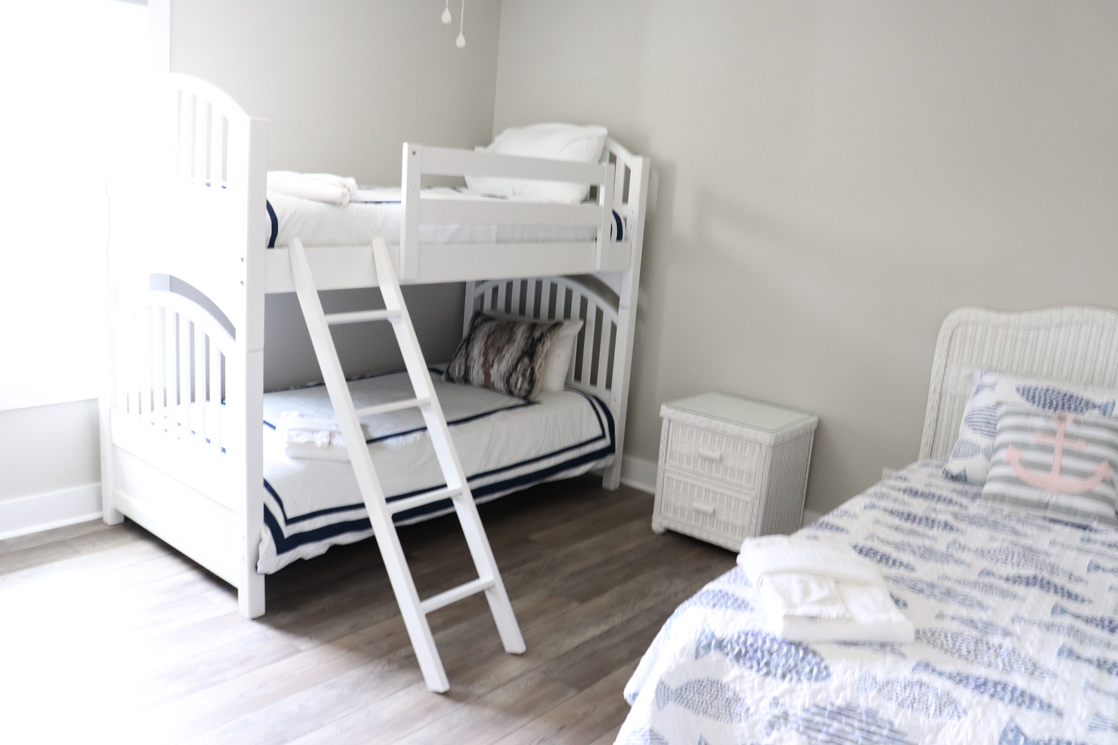 Your family's peaceful retreat features bright white bunk beds and twin accommodations, perfect for creating magical memories together.