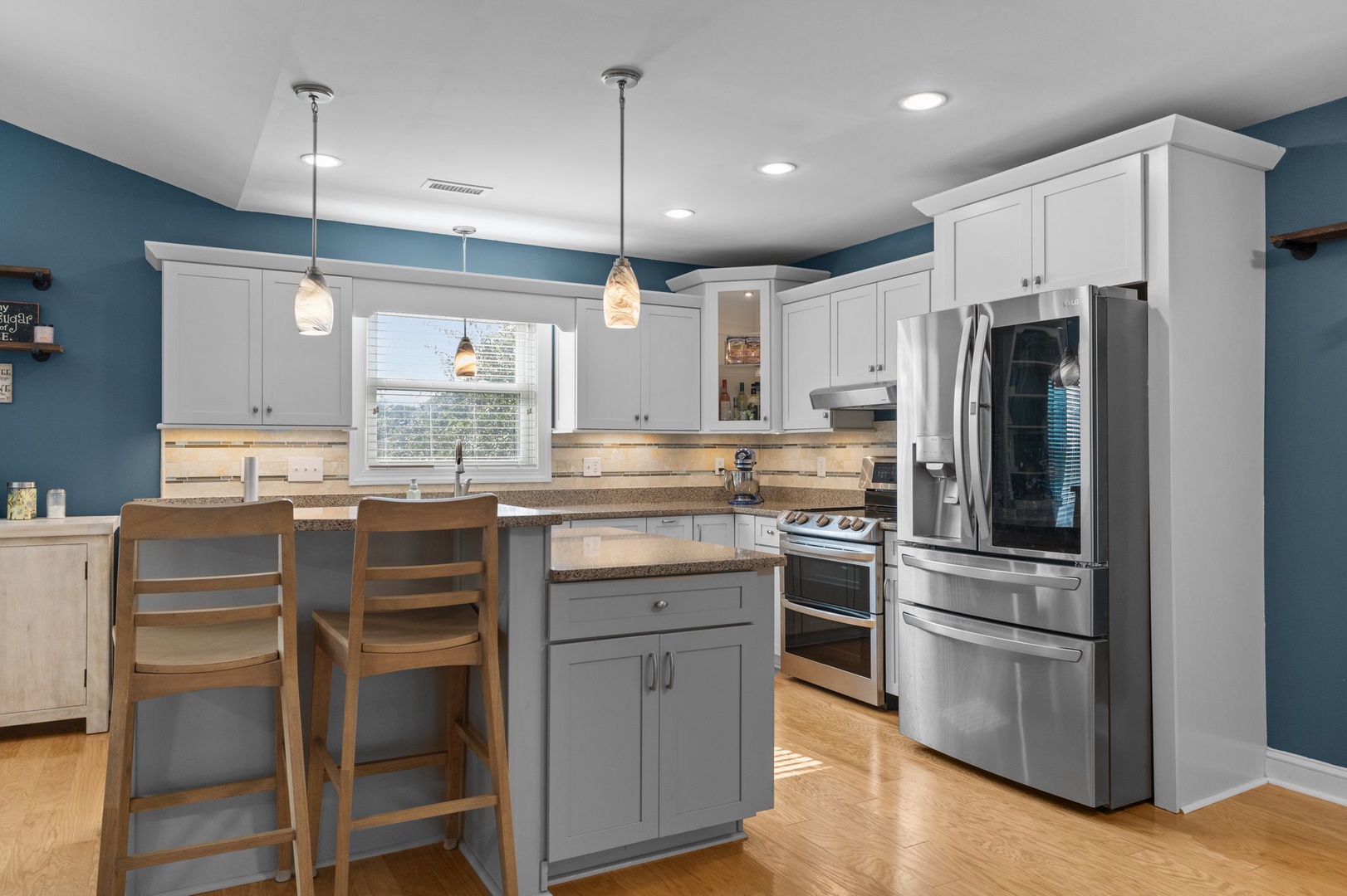 Your fully equipped modern kitchen features granite counters, stainless steel appliances, and a breakfast bar for morning coffee.