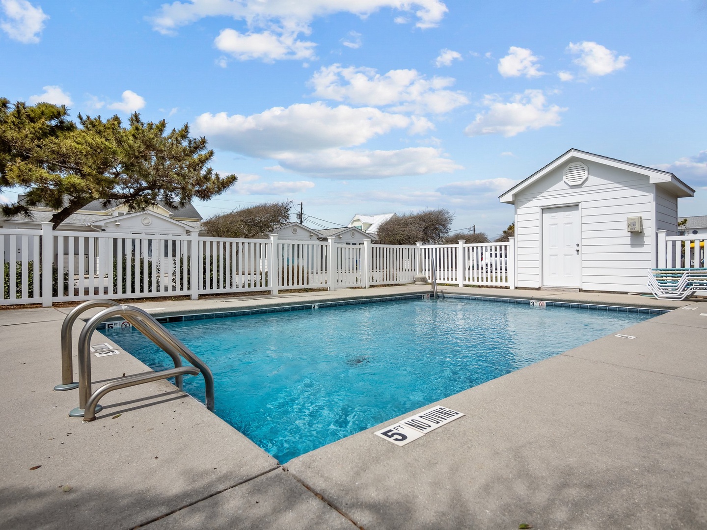 Dive into relaxation in this sparkling blue pool, perfectly positioned for your sunny afternoon swims and poolside lounging.
