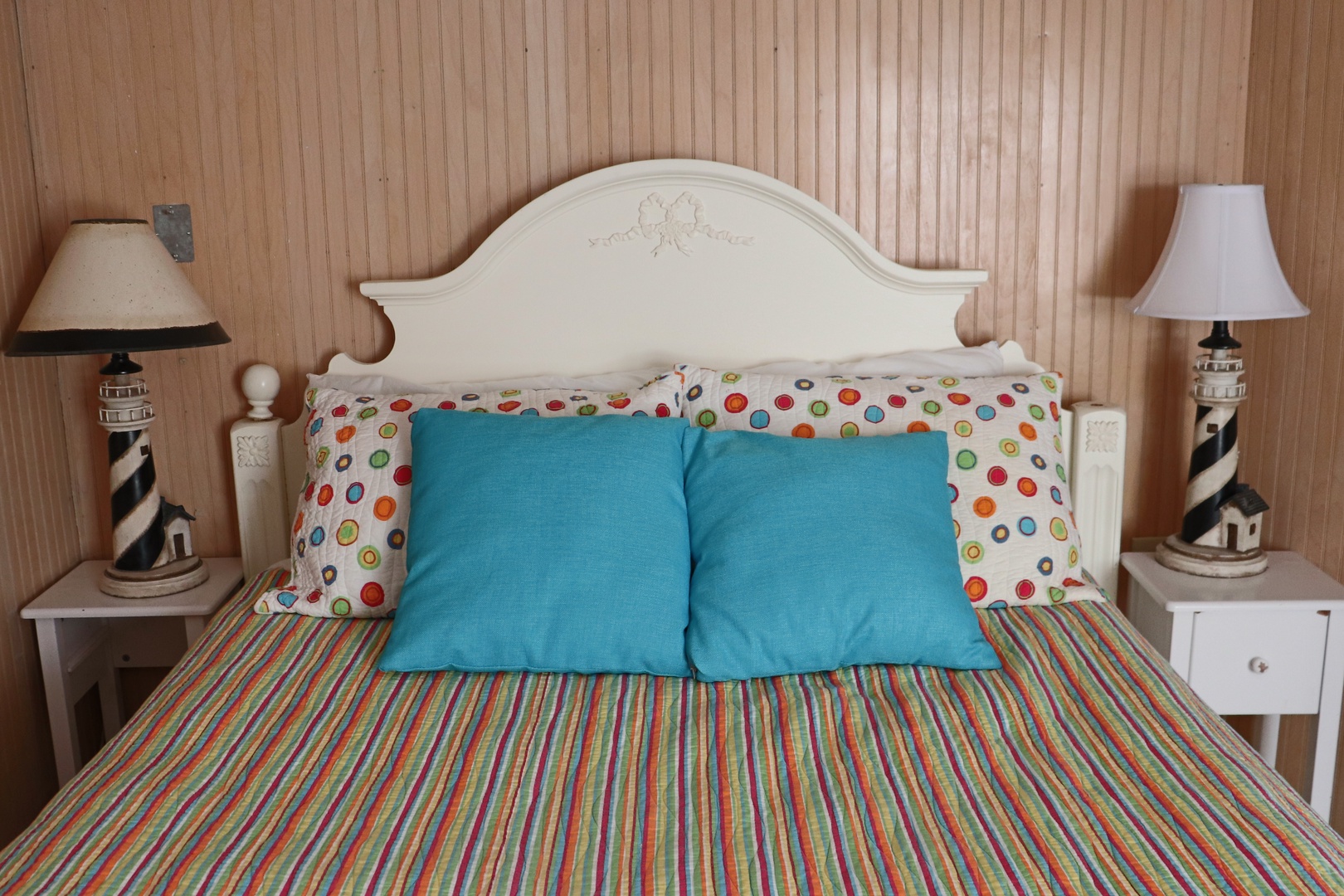 Rest peacefully in your charming coastal-themed bedroom, featuring lighthouse lamps and cheerful linens that create a warm, nautical atmosphere.