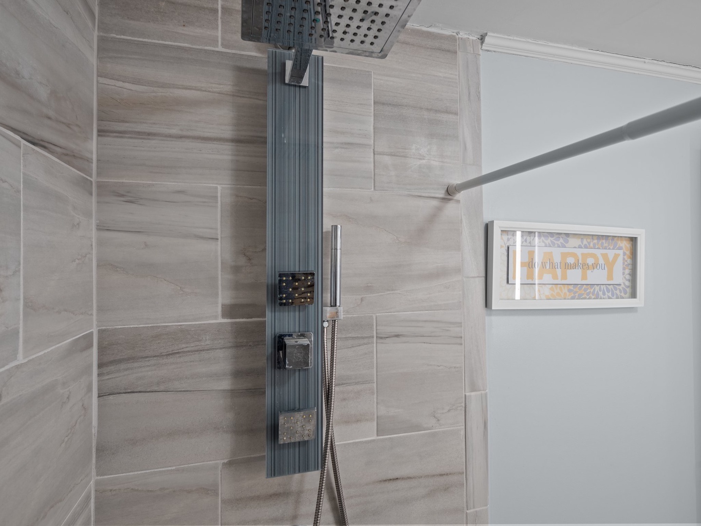 Step into your spa-like shower with dual rainfall and handheld options, surrounded by elegant wood-grain tiles for ultimate relaxation.
