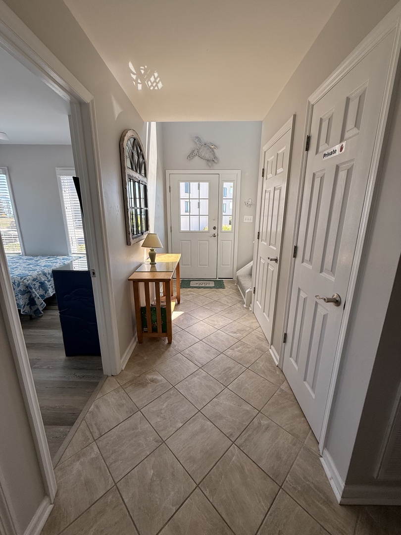 Your fully equipped kitchen features modern appliances and elegant tile flooring, with natural light streaming through the window to brighten your cooking space.