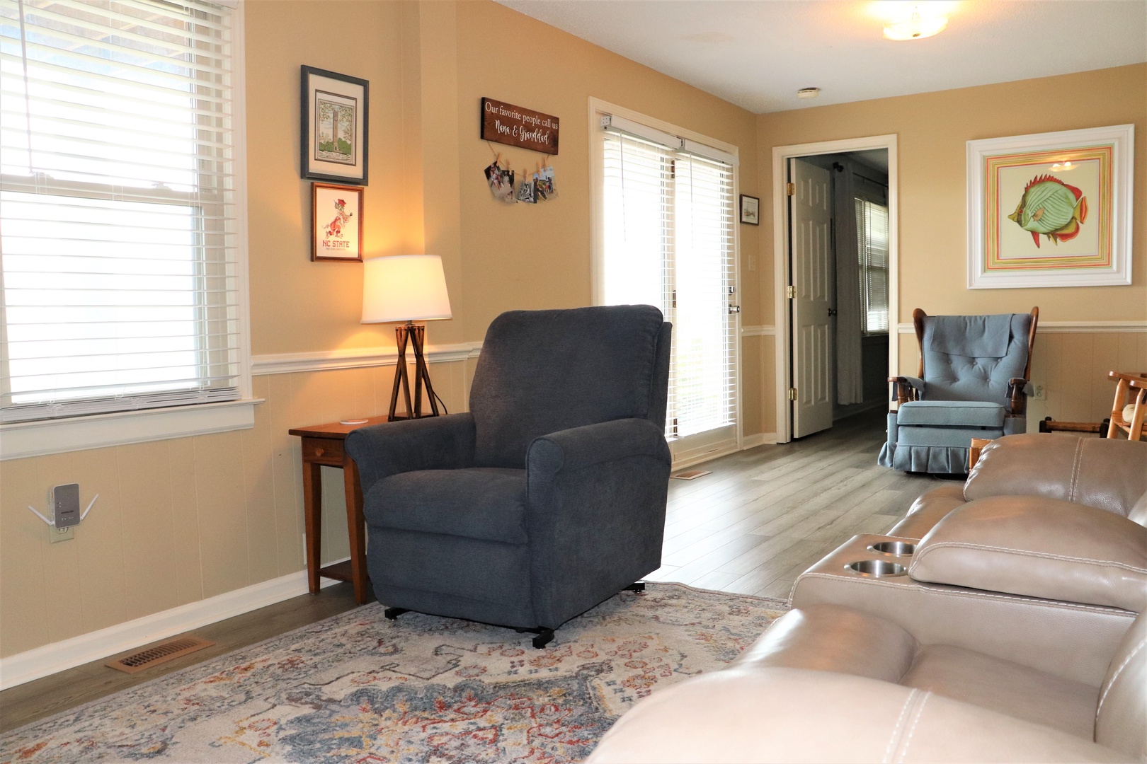 Unwind in your cozy living room with comfortable seating and warm afternoon light streaming through windows.