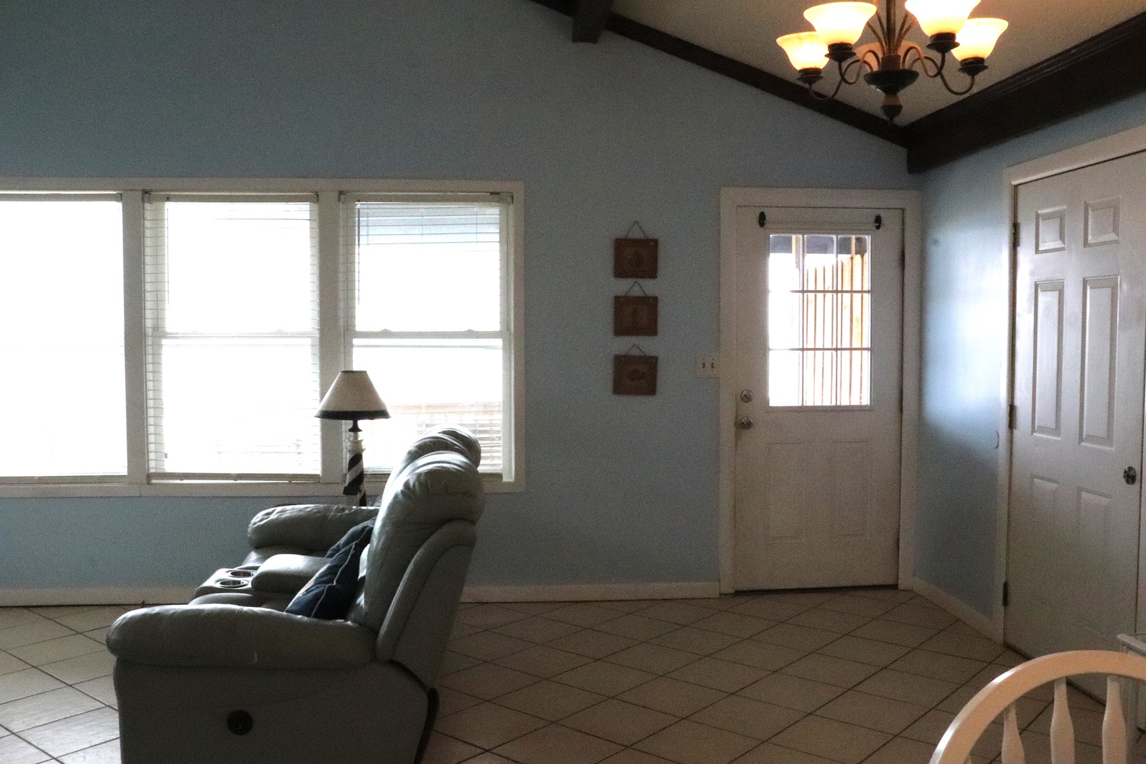 Relax in your spacious living area flooded with natural light from three large windows. The airy blue walls and cozy recliner create a peaceful retreat after your adventures.