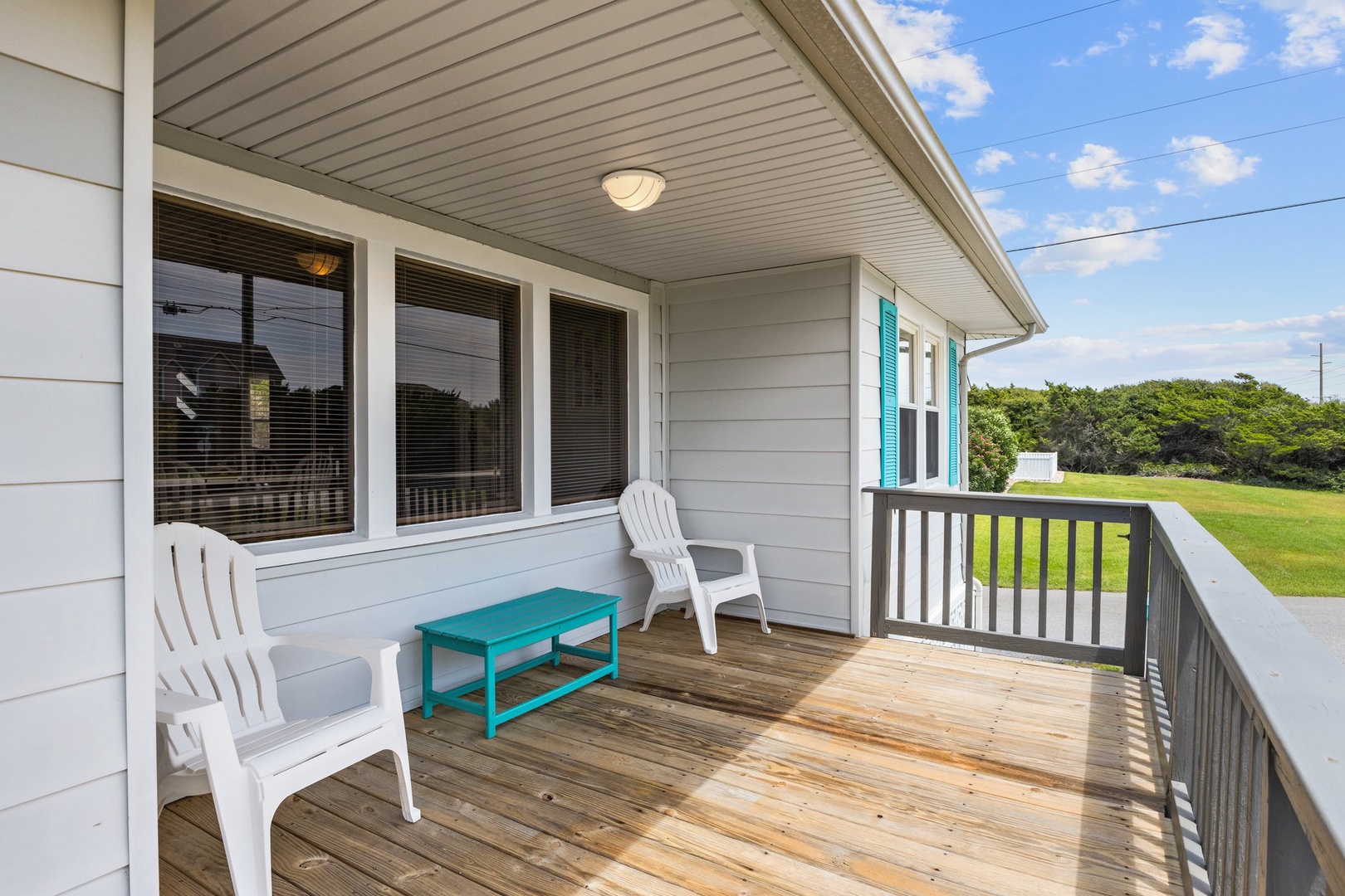 Your private covered deck invites you to relax in comfortable seating while enjoying peaceful field views and refreshing coastal breezes.