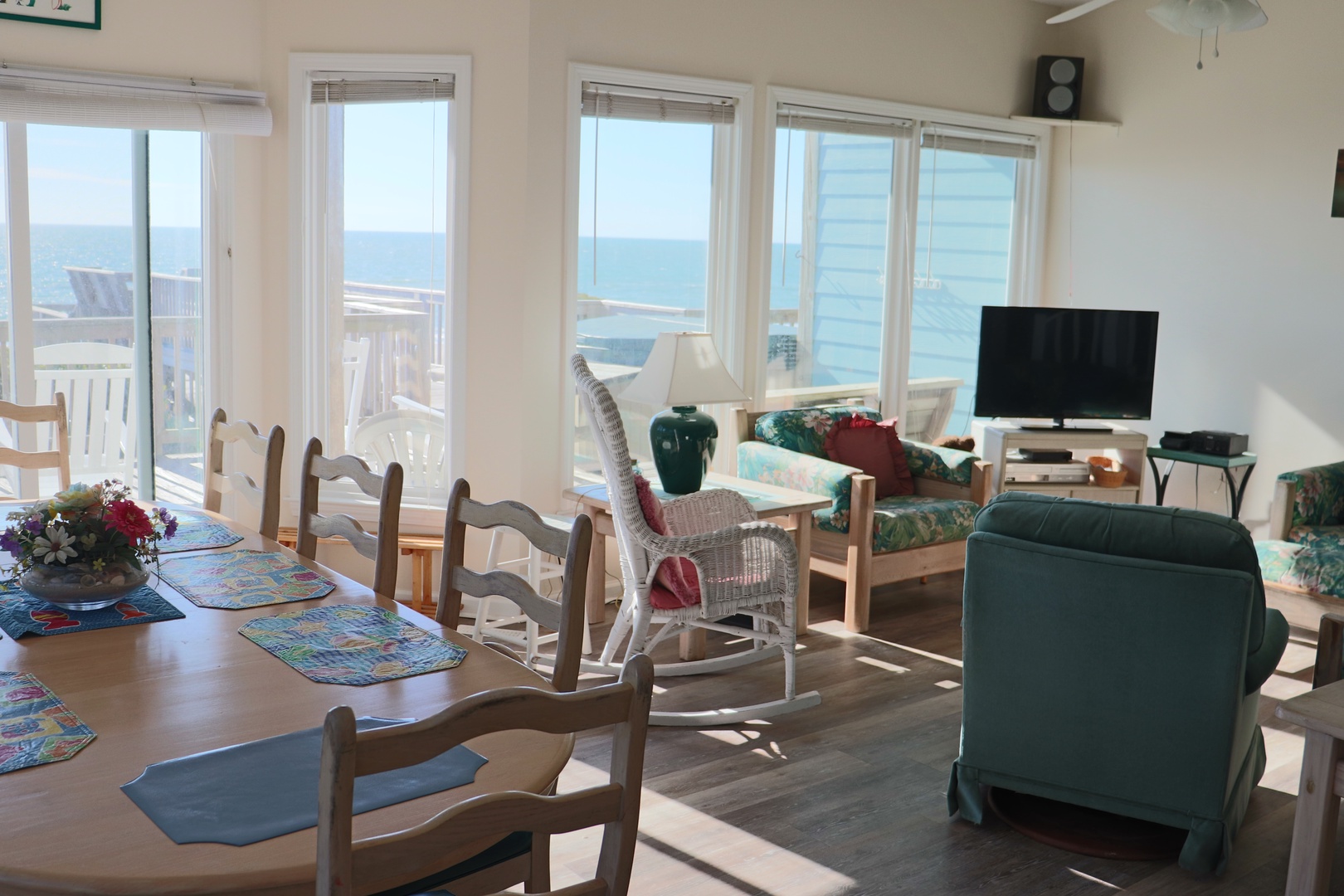 Relax in your bright living space with stunning sea views through floor-to-ceiling windows, where ocean breezes and coastal charm create your perfect retreat.