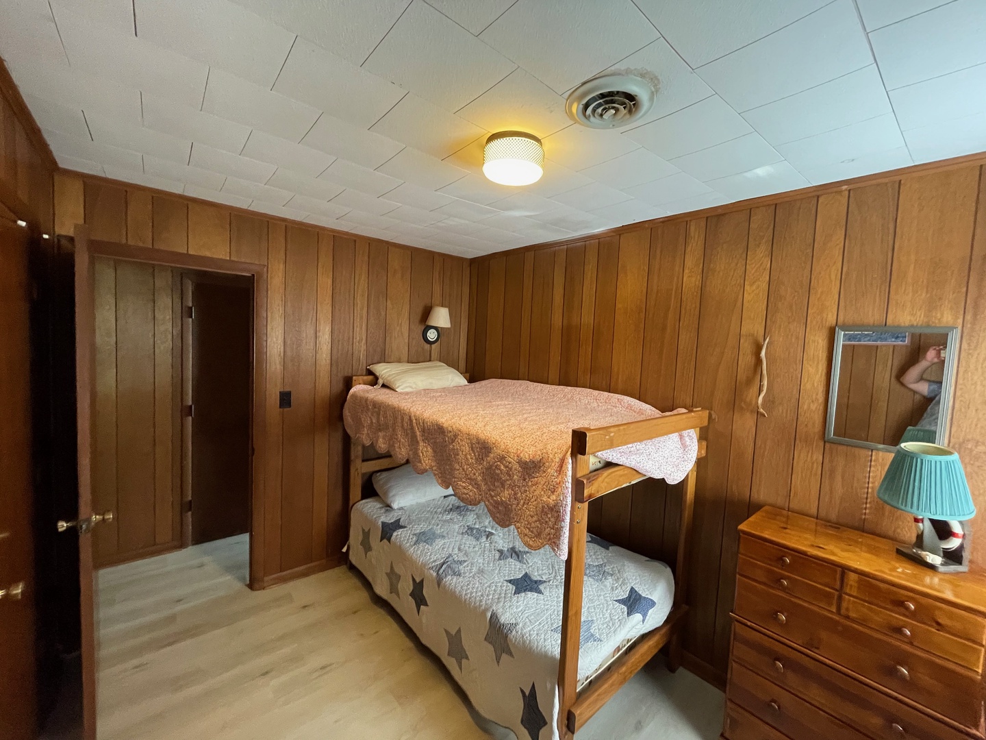 Your cozy bunk room features warm wood paneling and comfortable beds perfect for family stays or group adventures.